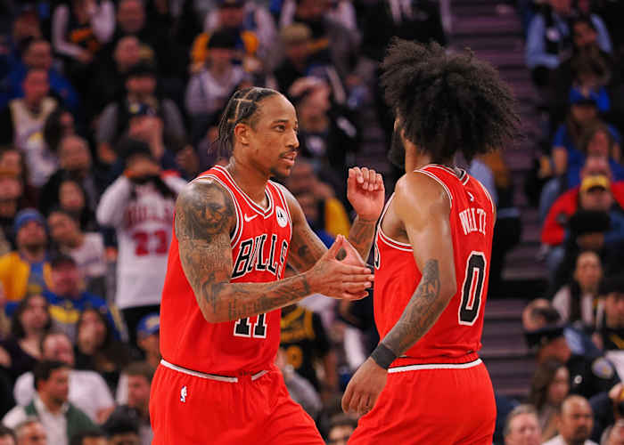 Chicago Bulls forward DeMar DeRozan (11) high fives guard Coby White (0) after a play against the Golden State Warriors during the fourth quarter at Chase Center.